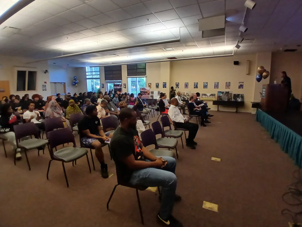 A room full of young men and adults seated for a Talented 10th session